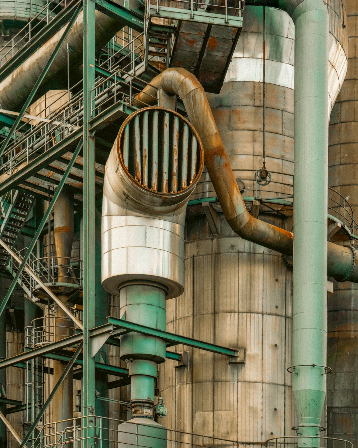 Rusted metal pipes and machinery at an industrial plant.